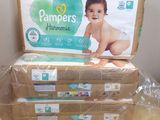 several boxes of diapers sitting on top of a wooden table