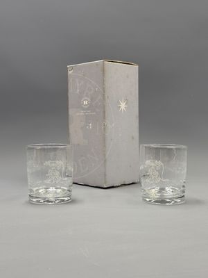 two glasses and a box on a table with a box in the background