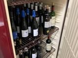 de nombreuses bouteilles de vin sur les étagères du réfrigérateur
