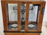 a glass display case with a clock inside of it