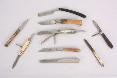 many different types of knives on a white surface