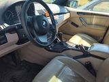 beige interior of a car with beige leather seats and a black steering wheel