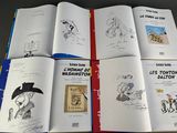 a lot of books that are open on a table