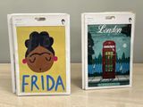 two luggage tags with a picture of frida and a telephone booth