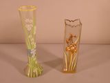 two vases that have flowers in them on a table