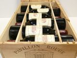 bottles of wine are in a wooden box on a table