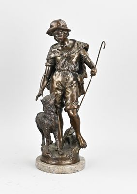 a bronze statue of a man with a dog and a stick
