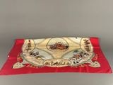 an old red cloth with a picture of a horse and carriage on it