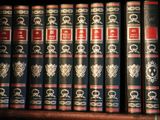 many books that are on a shelf in a library