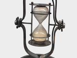 an old hourglass on a stand on a white background