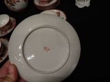 a person holding a white plate with a red design on it