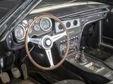 a dashboard and steering wheel of a car in a garage
