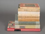 several books stacked on top of each other on a table