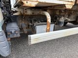 a truck that has a lot of rust on the side of it