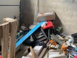 a pile of boxes and other items in a garage
