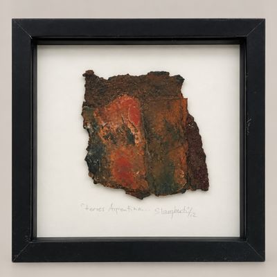 framed photograph of a piece of rusted paper with writing on it