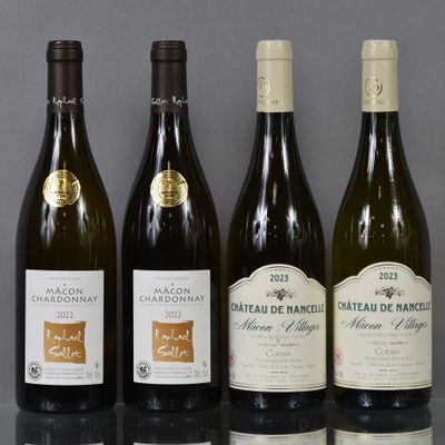 several bottles of wine are lined up on a glass table
