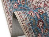 a close up of a blue rug with a floral design on it