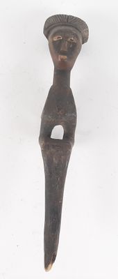 wooden figurine of a woman with a hat on her head