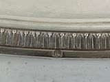 a silver plate with a group of people on it