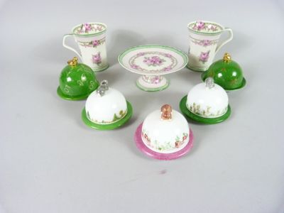 five small dishes and cups sitting on a table