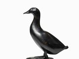statue of a duck on a pedestal on a white background