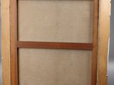 an easel with a painting on it and a wooden frame