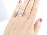 a woman ' s hand with a diamond ring on it