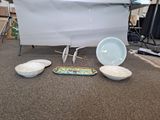 a table with bowls and plates on it in a room