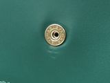 a close up of a green purse with a gold button
