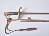 two swords and a knife on a white surface