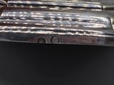 an antique silver plate with a bell on top of it