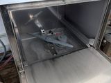 a silver dishwasher sitting inside of a silver oven