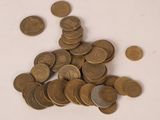 a pile of coins sitting on a white surface