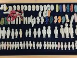 a lot of small figurines in a wooden frame