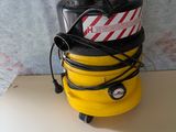 a yellow and black vacuum sitting on top of a white table