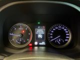 a close up of a car dashboard with various gauges