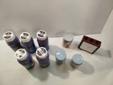 several cans of paint, a picture frame, and a picture on a table