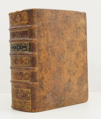 an old book sitting on top of a white surface