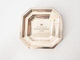 an image of a silver plate on a white surface