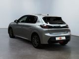 the rear of a silver car is parked in a white room
