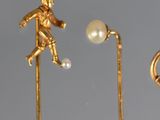 a gold figurine of a man kicking a soccer ball