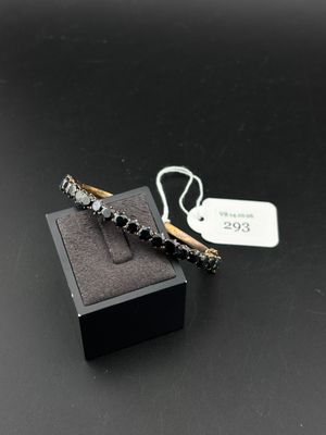 a close up of a pair of earrings on a black surface