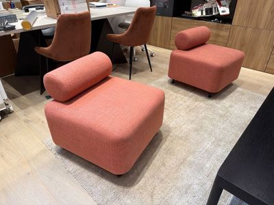 two chairs and a ottoman in the middle of a room