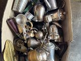 a box full of silver and brass items on the floor