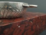 a silver bowl sitting on top of a red box
