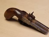 a close up of a wooden toy gun on a table