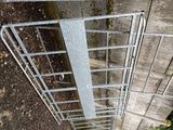 a metal gate that has a bunch of steps going up it