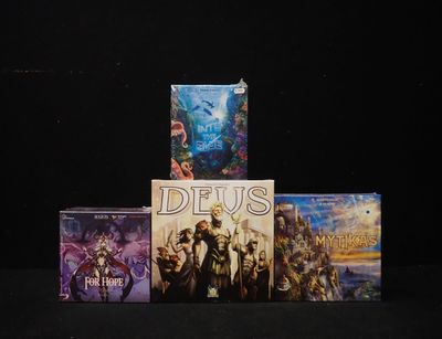 several video games sitting on top of a table on a black surface
