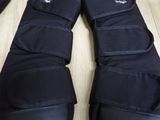a pair of black boots that are on a table